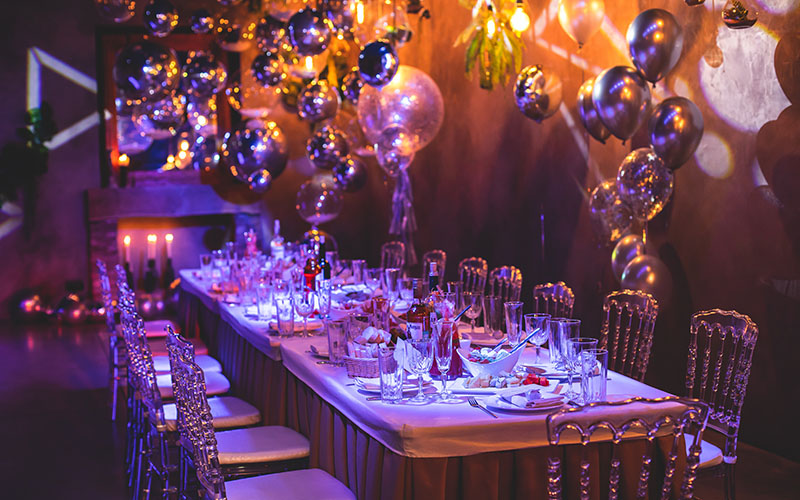 Decoration interior elements of restaurant venue banquet hall with multicoloured different helium balloons, on a indoor corporate event or wedding reception or a birthday party celebration