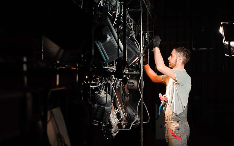 The stage worker sets up the lights