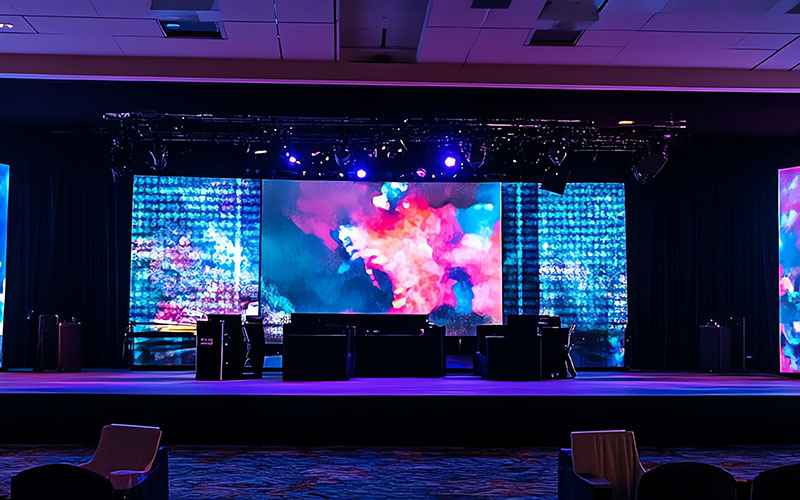 Vibrant stage setup with colorful screens and lights ready for an event.