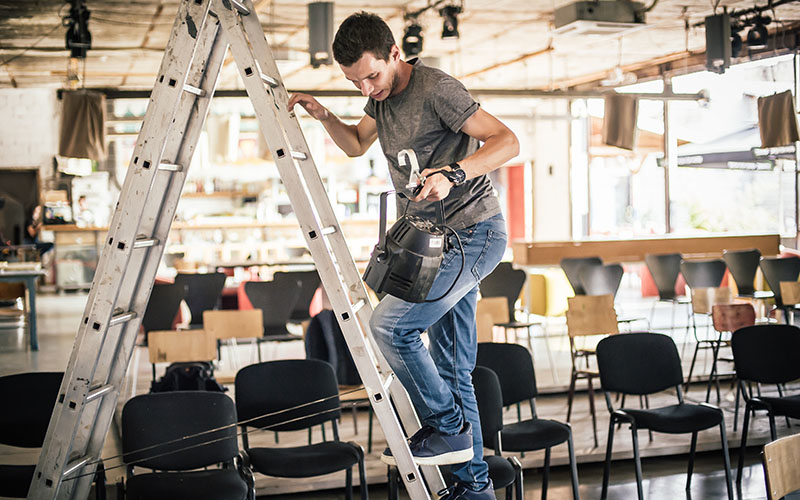 Behind the scene. Lighting technician electric engineer adjusting stage lights